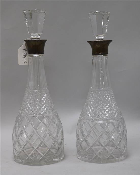 A pair of silver collared decanters